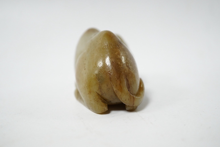 A Chinese carved jade figure of a recumbent Bactrian camel, 7.5cm long. Condition - good